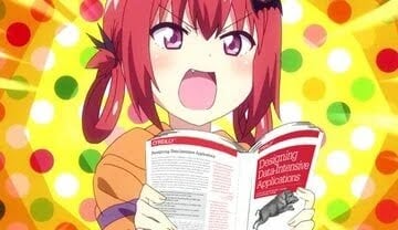 Anime girl excitedly reading Designing Data-Intensive Applications